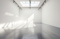 Empty white cube gallery with skylight and geometric shadows